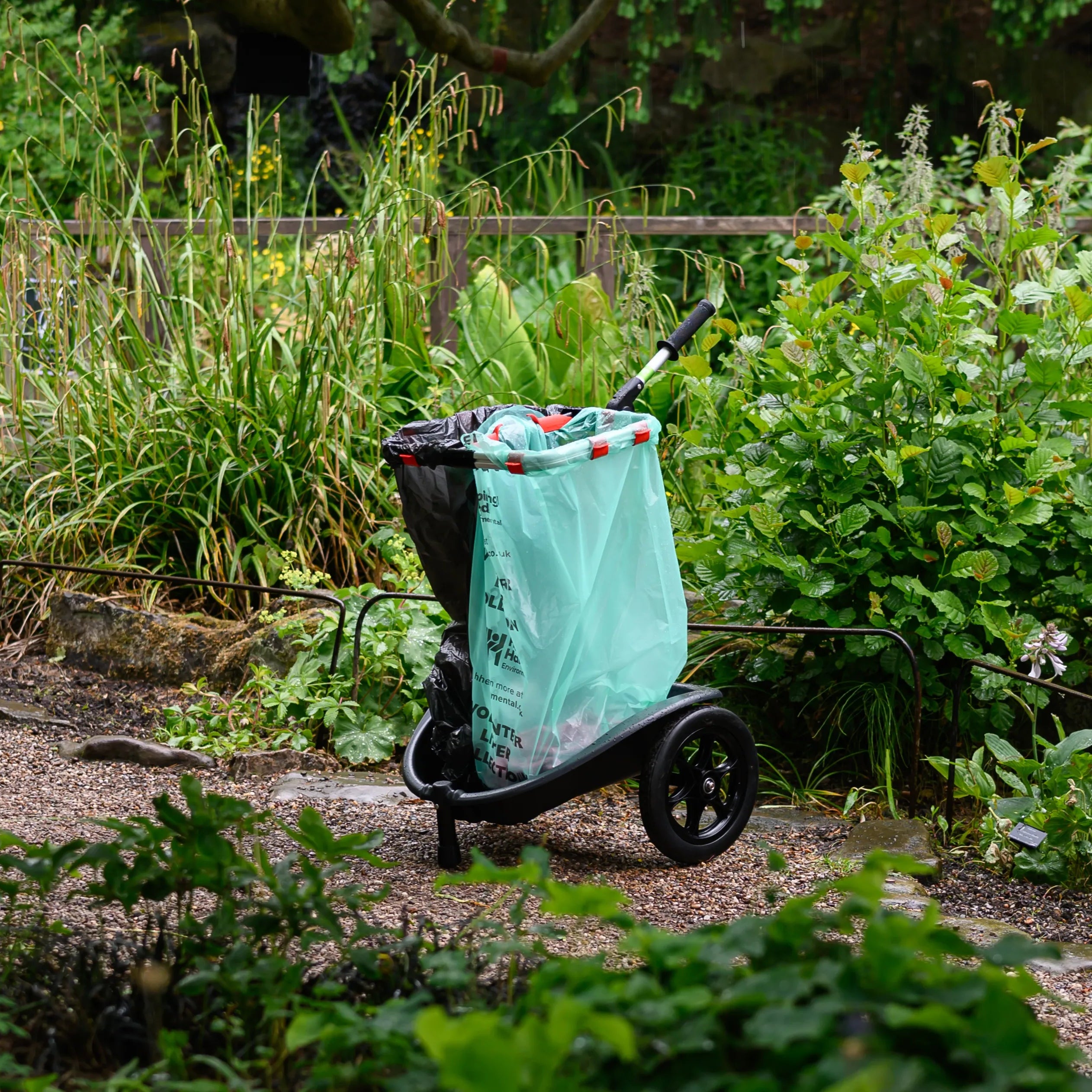 Cart with a green bag in a garden setting