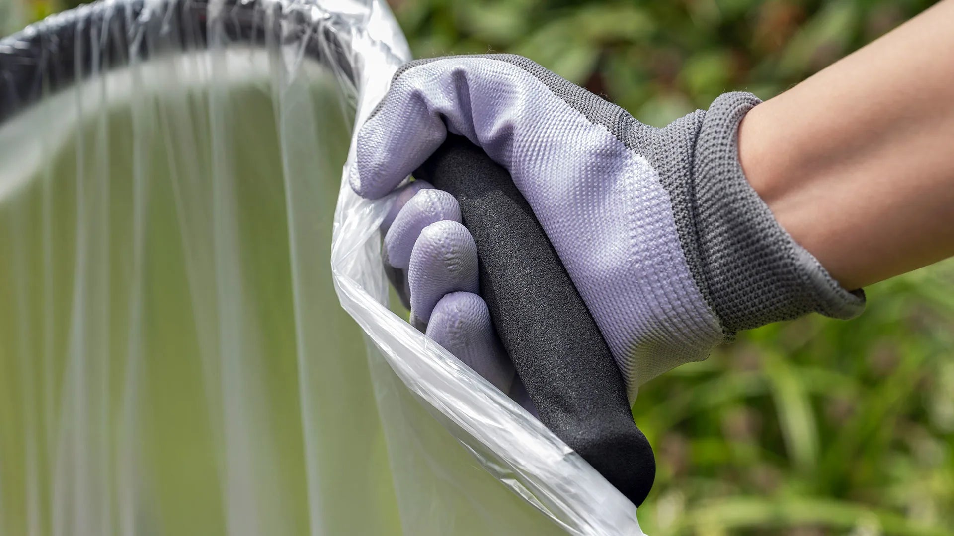 Person wearing gardening gloves holding Handi Hoop Foam Handle.