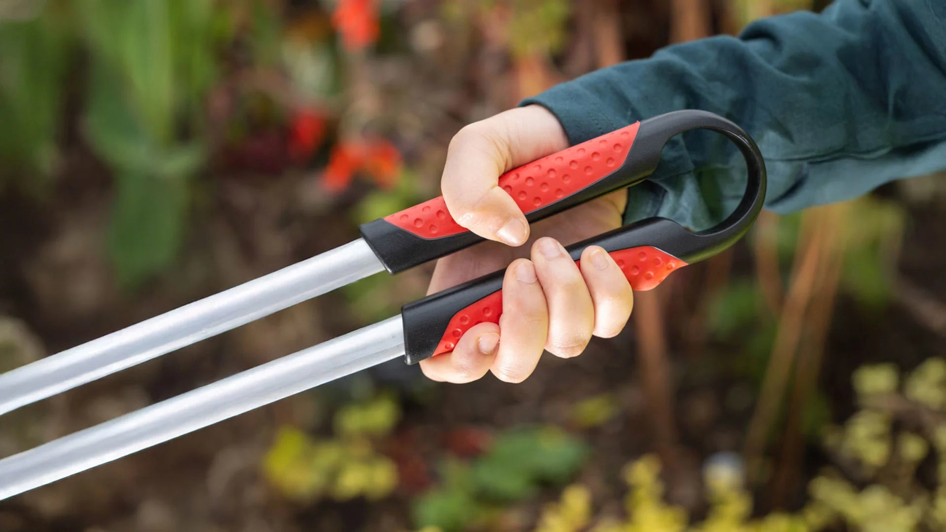 Person grabbing Range Max straight handle litter picker.