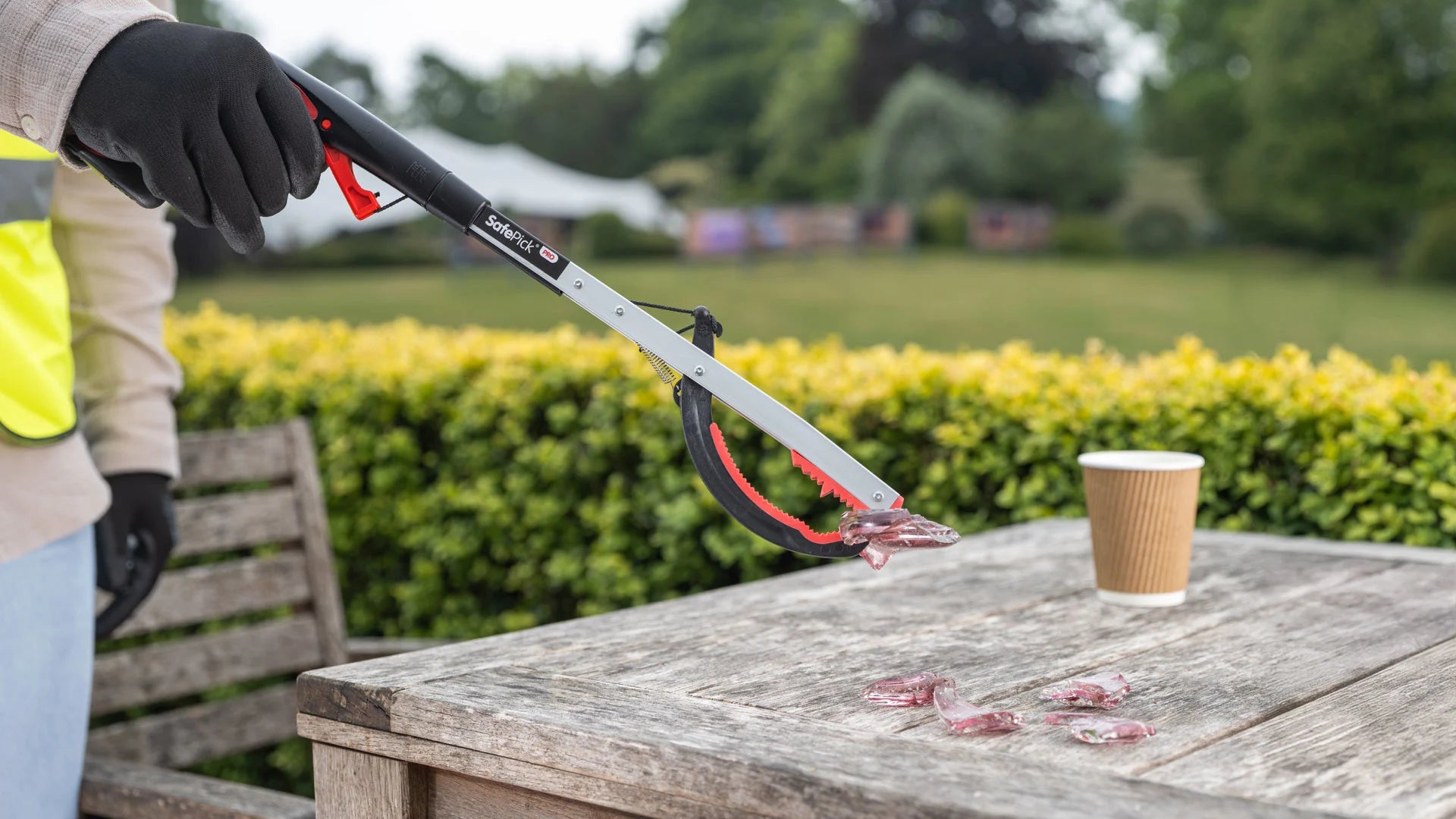 Person picking up broken glass with the Safepick Pro litter picker.