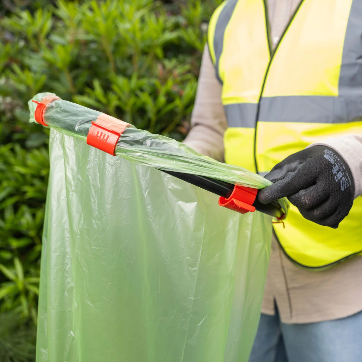 Volunteer holding Handi Hoop Clip Litter Hoop.