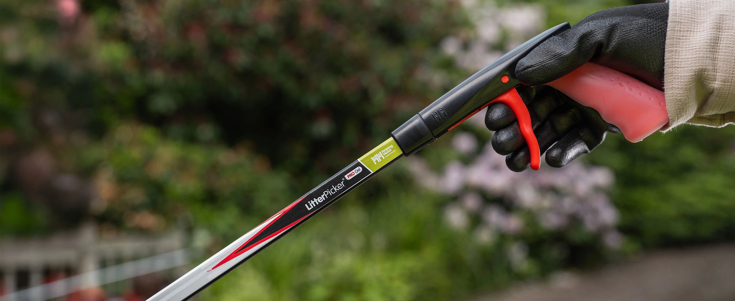 Volunteer grabbing Litter Picker Pro Gel handle.
