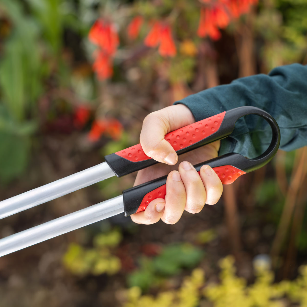 Person grabbing Ranger Max Straight heavy duty litter picker.