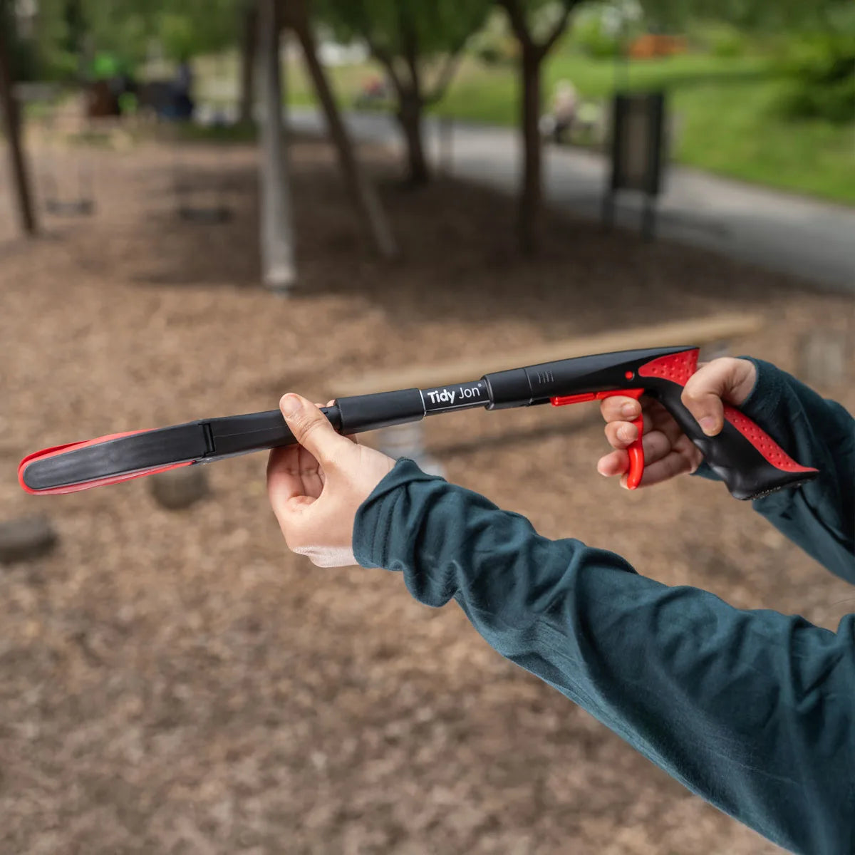 Person holding Tidy Jon Litter Picker in an outdoor setting.