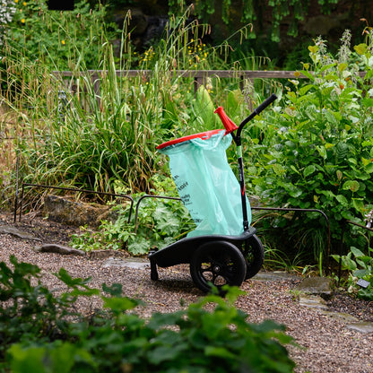 Cart with a green bag in a garden setting