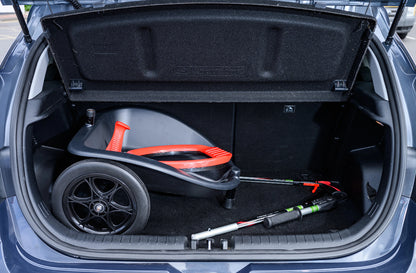 Open car trunk with a folded litter cartinside