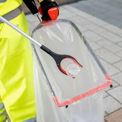 Person using Streetmaster Pro rotating head litter picker to pick up plastic bottle.