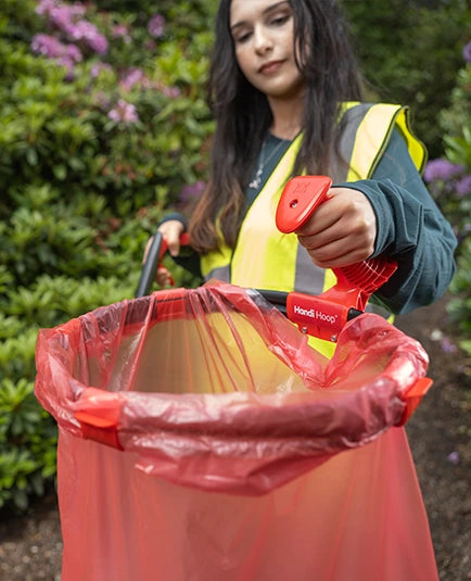Person holding Handi Hoop for litter grabbing.