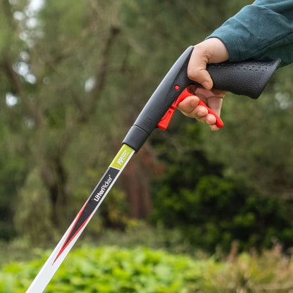 Person holding litter picking stick with a blurred natural background.