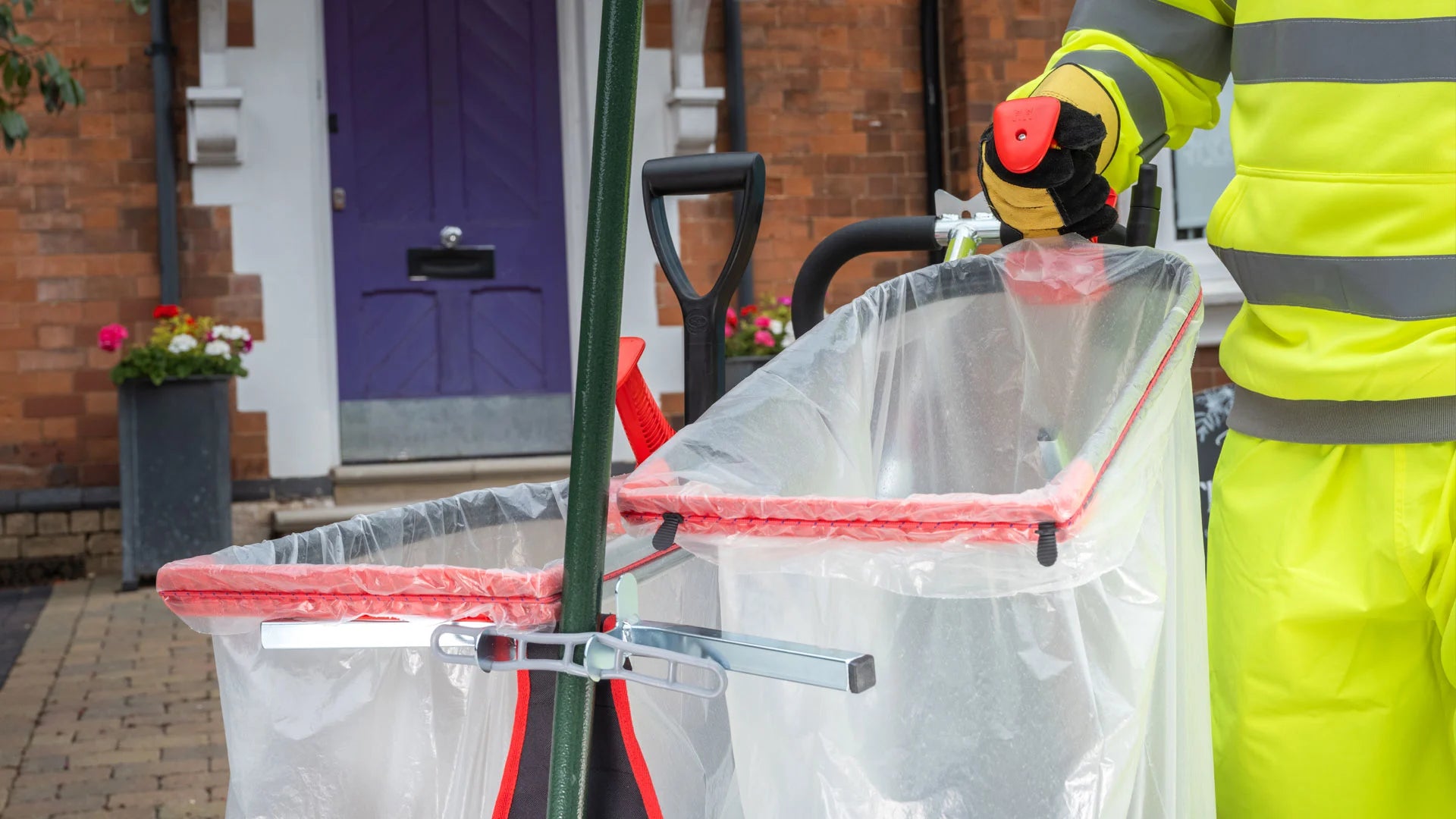 Person in high-visibility clothing using a litter picker tool station. 