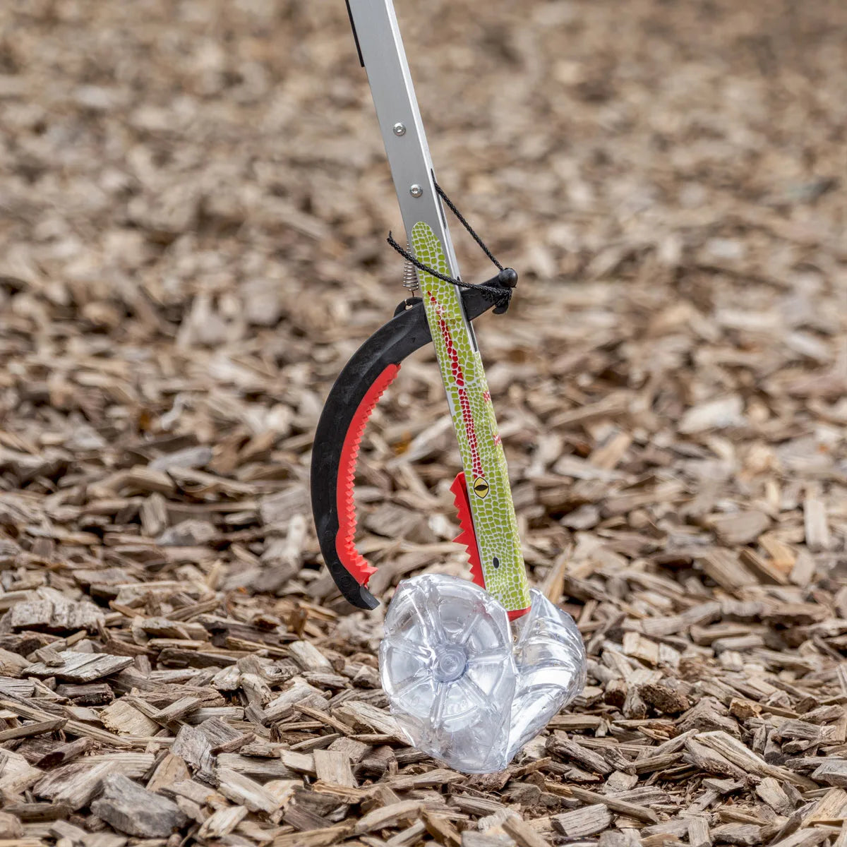 Graptor Kids litter picker grabbing plastic bottle.