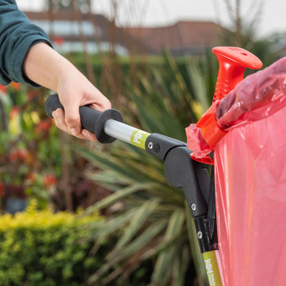 Person grabbing Handi Cart Lite litter picking trolley outdoors. 