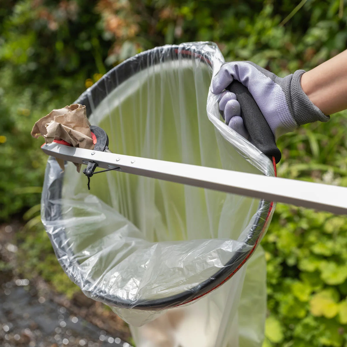 Handi Hoop Foam Bungee Cord litter hoop held by a volunteer.