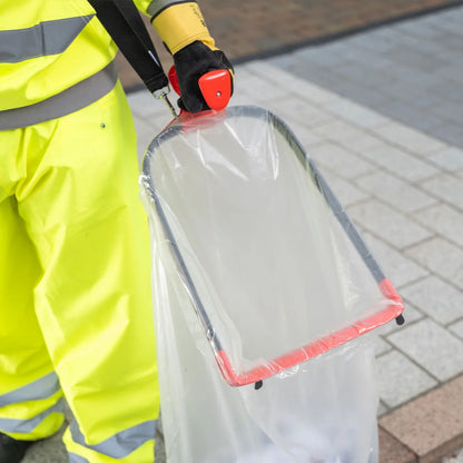 Person in high-visibility clothing using a Handi Hoop Plus Litter Hoop.