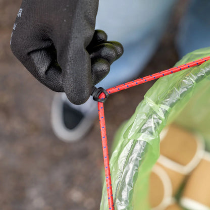 Volunteer pulling Handi Hoop Pro Bungee Cord litter hoop for litter picking.