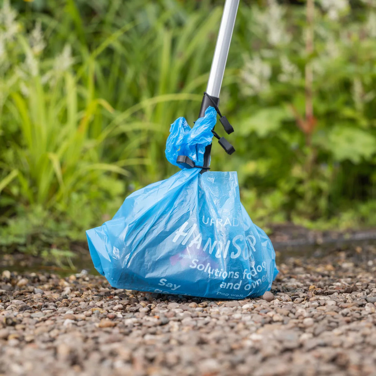 Handi Scoop Pro Pooper Scooper grabbing waste.