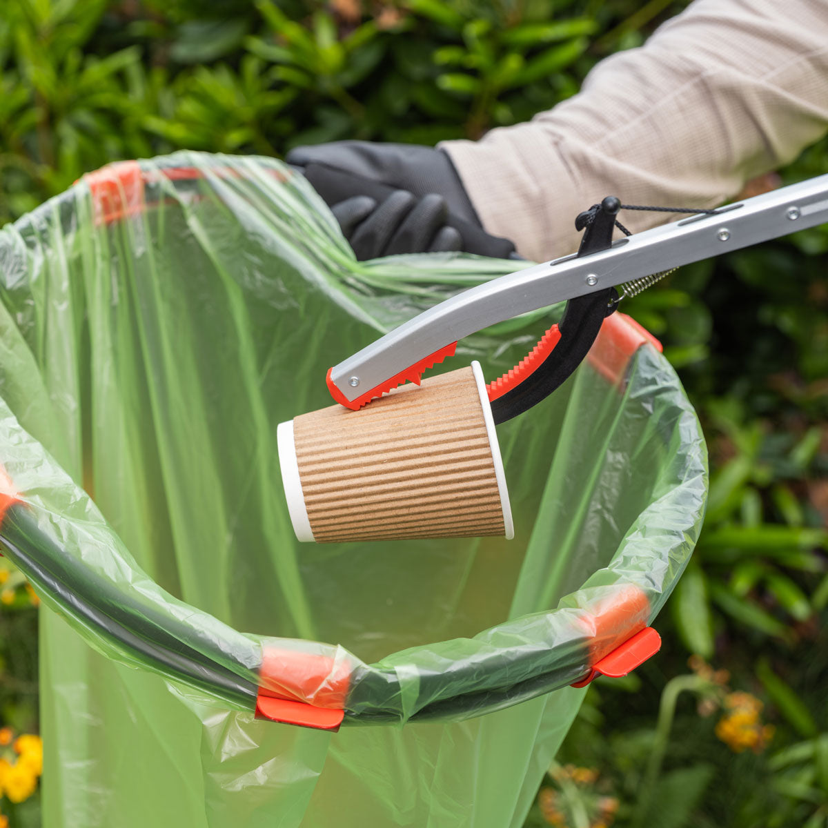 Person picking paper cup with Litterpicker Pro Gel.