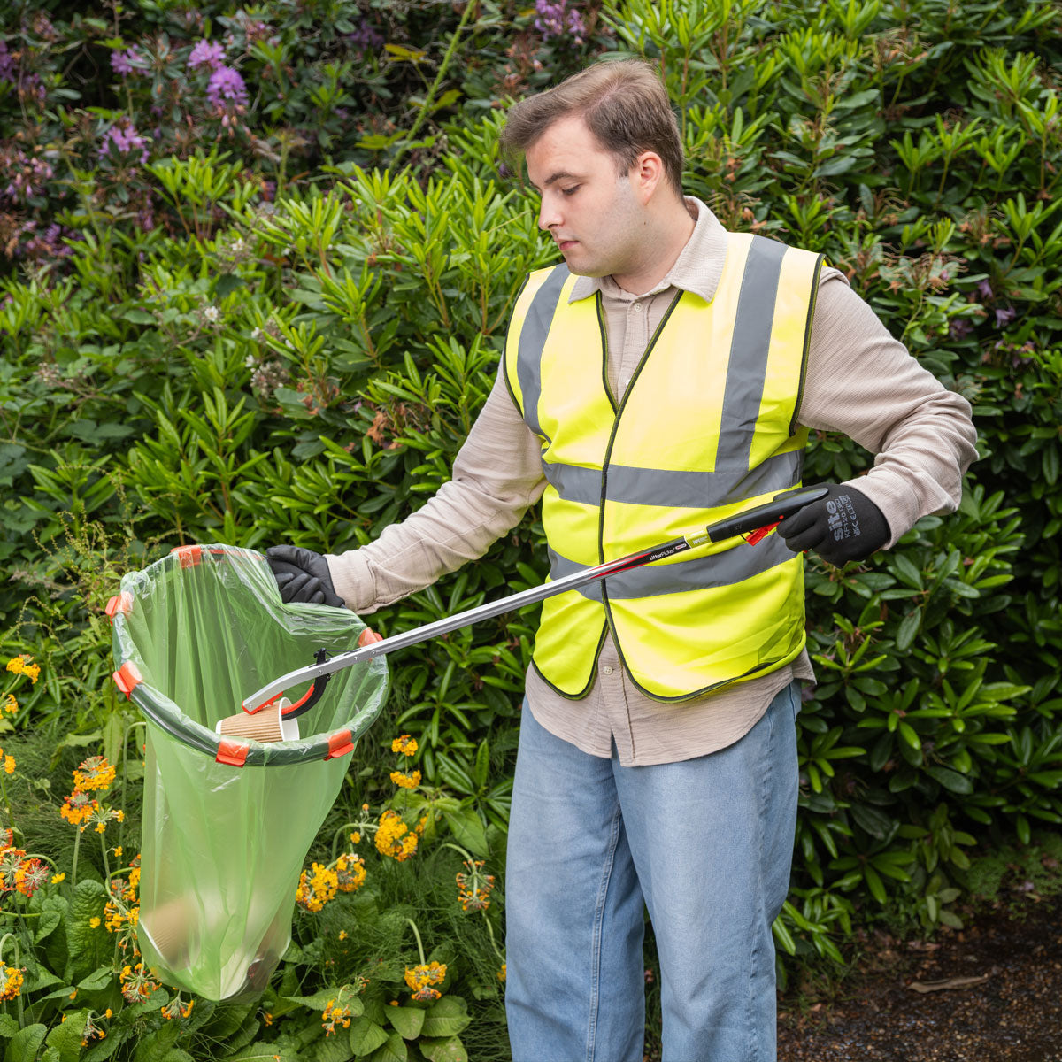 Volunteer worker picking up litter with Litter Picker Pro Gel.
