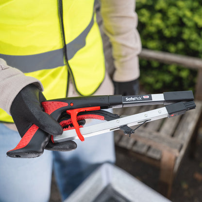 Volunteer holding folded SafePick litter picker.