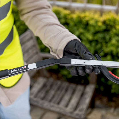 Volunteer worker folding SafePick Pro litter picker.