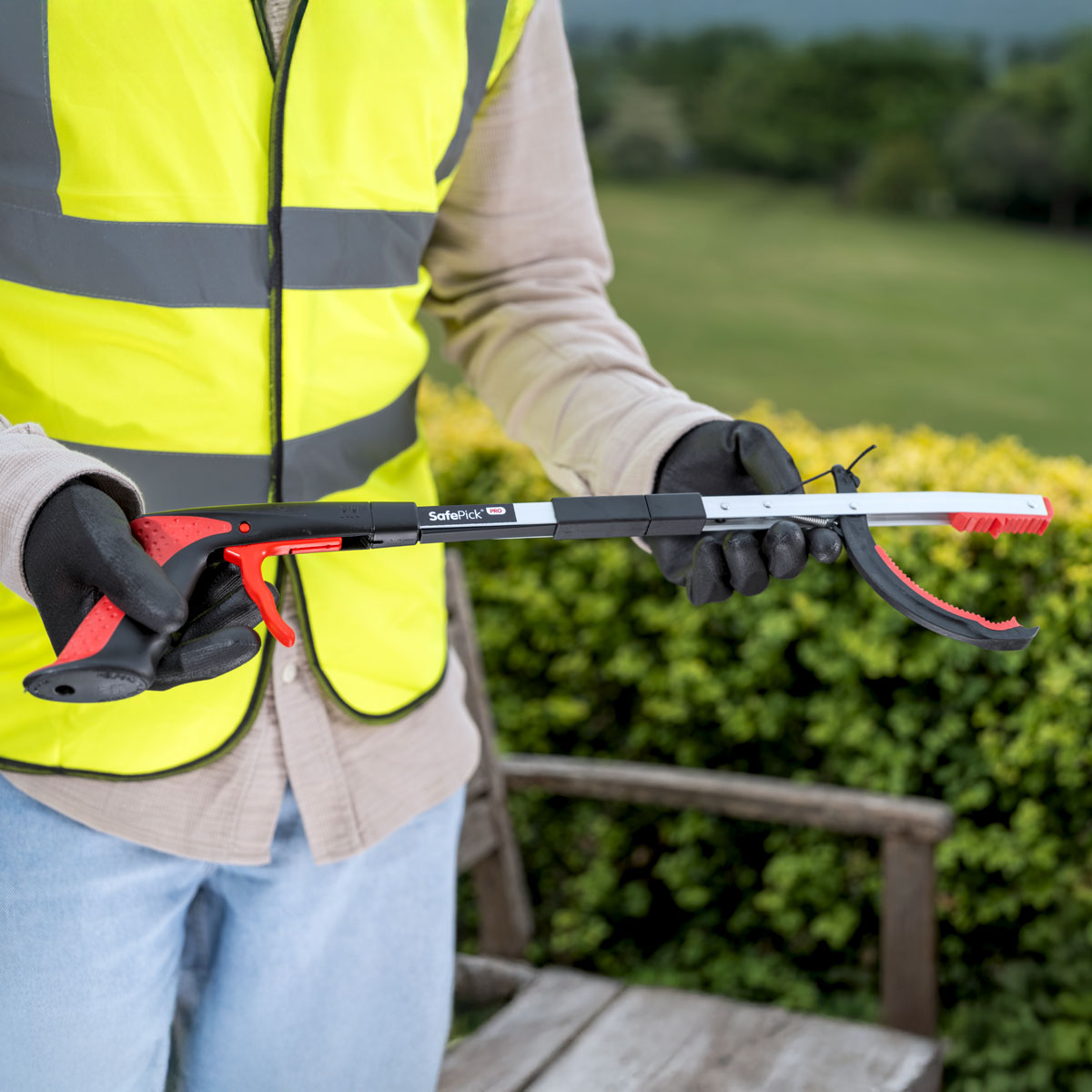 Person holding Safepick Pro folding litter picker.