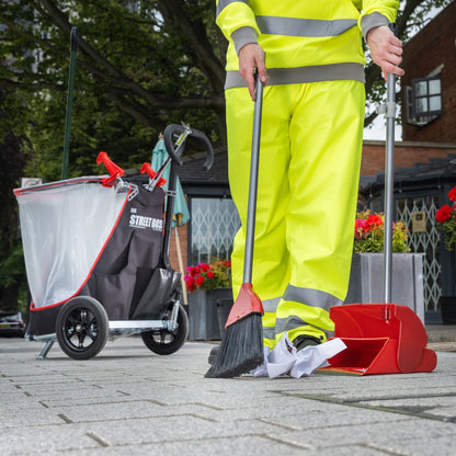 Person in high vis clothing cleaning trash with Street Boss litter tool-station. 
